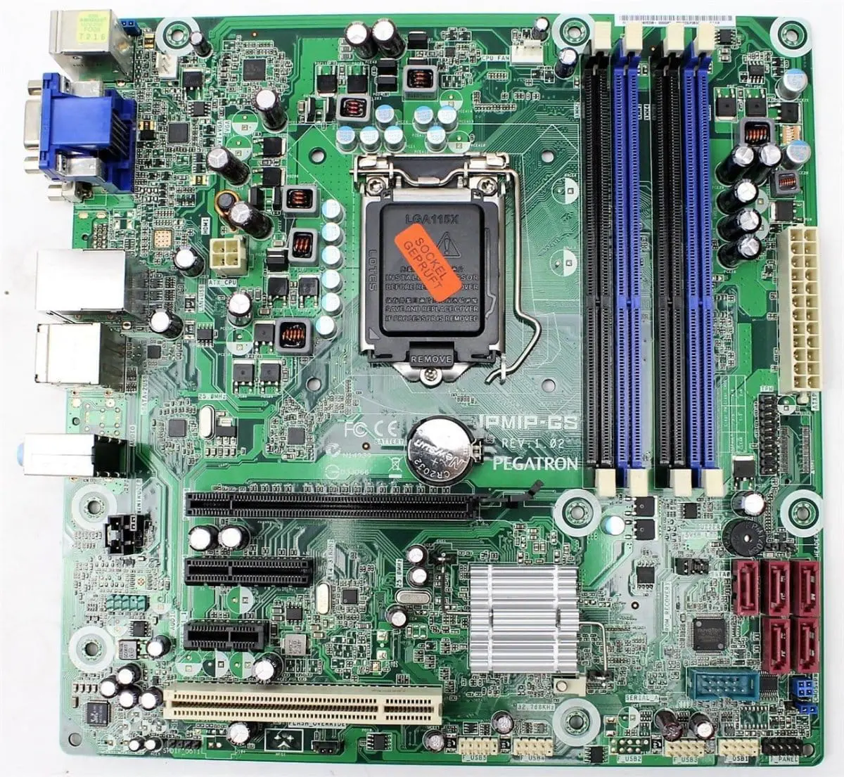 Pegatron IPMIP-GS LGA1156 motherboard front view showing CPU socket with protective cover, RAM slots, capacitors, and integrated heatsink